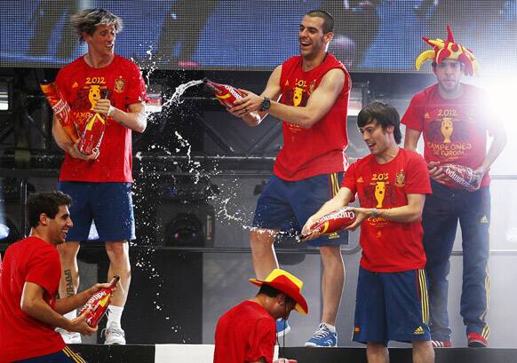 Javi Martinez, Fernando Torres, Negredo, David Silve, Santiago Cazorla and Jordi Alba throw drink to each other during the celebration of the Euro 2012 soccer championship in Madrid.