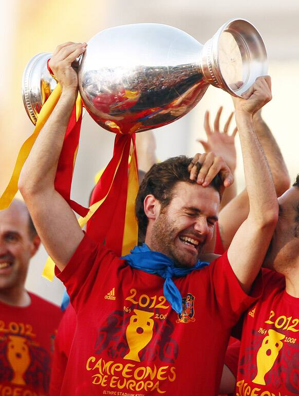 Juan Matta holds the trophy with teammates during the celebration of the Euro 2012 soccer championship in Madrid.