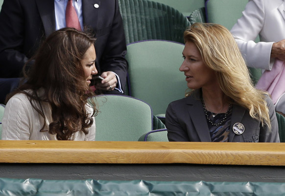 Kate, Duchess of Cambridge, speaks with retired tennis player Steffi Graf as Andy Murray of Britain faces David Ferrer of Spain in a quarterfinals match at the All England Lawn Tennis Championships at Wimbledon.