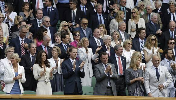 Prince William, Kate, retired tennis players Andre Agassi,  and Steffi Graf applaud after Roger Federer of Switzerland defeated Mikhail Youzhny of Russia.