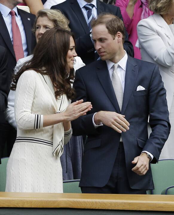 Britain's Prince William and Kate, Duchess of Cambridge applaud after Roger Federer of Switzerland defeated Mikhail Youzhny of Russia during a quarterfinals match at the All England Lawn Tennis Championships at Wimbledon.