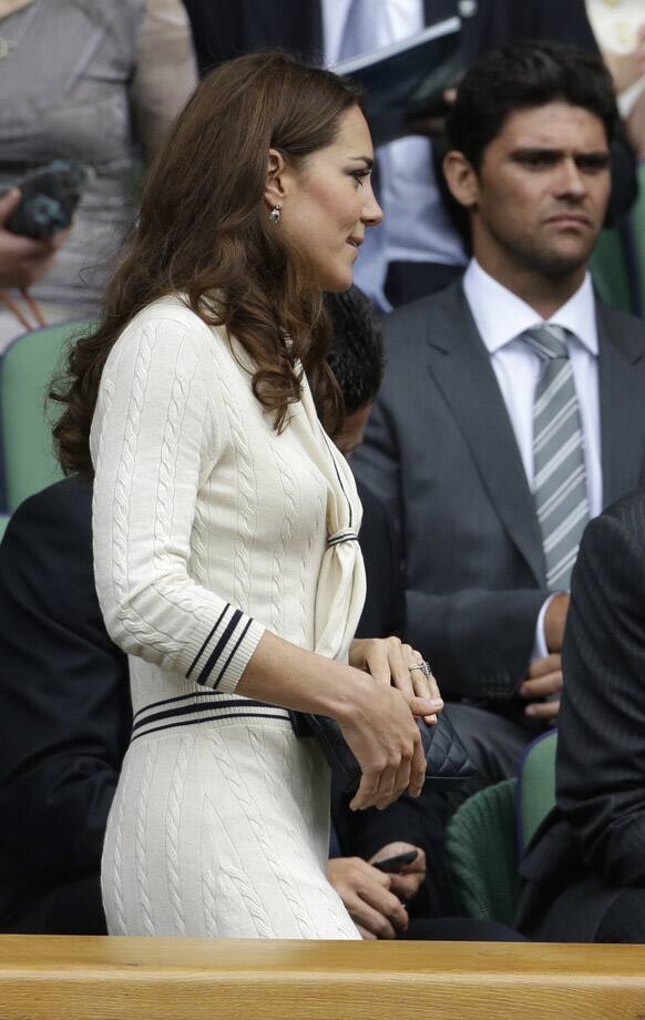 Britain's Kate, Duchess of Cambridge returns to the Royal box as play resumes between Roger Federer of Switzerland and Mikhail Youzhny of Russia during a quarterfinals match at the All England Lawn Tennis Championships at Wimbledon.