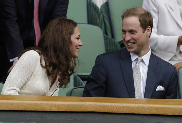 Britain's Prince William and Kate, Duchess of Cambridge watch Roger Federer of Switzerland play Mikhail Youzhny of Russia during a quarterfinals match at the All England Lawn Tennis Championships at Wimbledon.