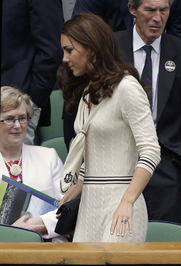 Kate, Duchess of Cambridge leaves the Royal box as rain delays play in a quarterfinals match between Roger Federer of Switzerland and Mikhail Youzhny of Russia at the All England Lawn Tennis Championships at Wimbledon.