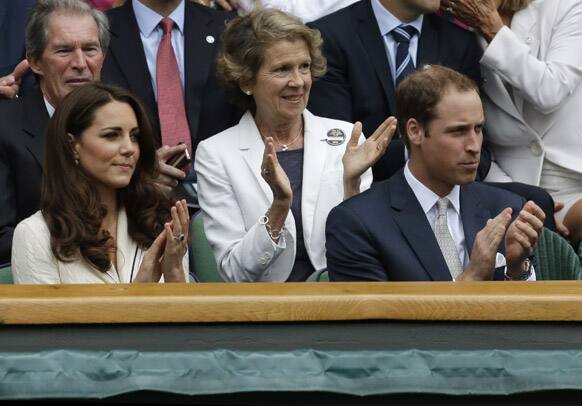 Britain's Prince William and his wife Kate, Duchess of Cambridge applaud during the quarterfinals match between Roger Federer of Switzerland and Mikhail Youzhny of Russia at the All England Lawn Tennis Championships at Wimbledon.