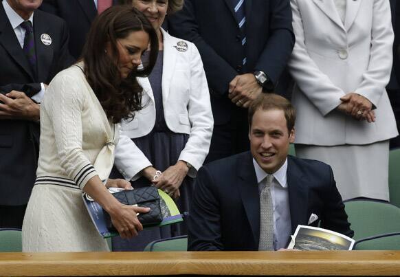 Britain's Prince William and Kate, Duchess of Cambridge watch Roger Federer of Switzerland play Mikhail Youzhny of Russia during a quarterfinals match at the All England Lawn Tennis Championships at Wimbledon.