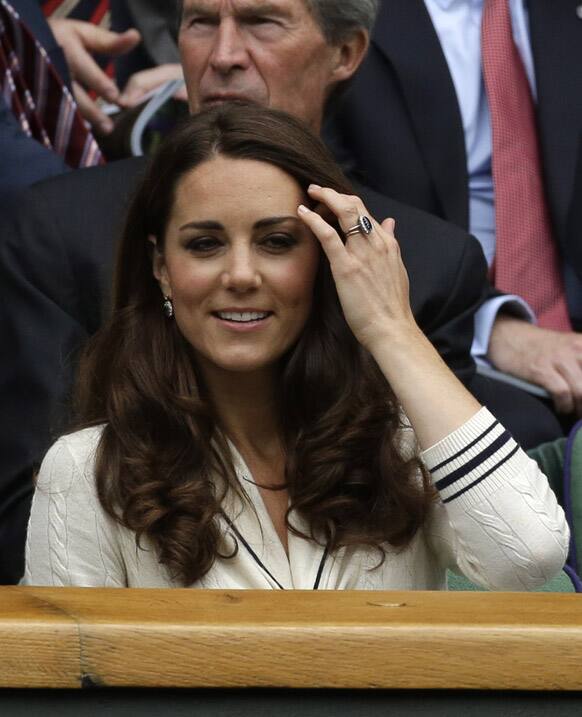 Kate, Duchess of Cambridge watch Roger Federer of Switzerland play Mikhail Youzhny of Russia during a quarterfinals match at the All England Lawn Tennis Championships at Wimbledon.