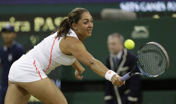 Tamira Paszek of Austria plays a return to Victoria Azarenka of Belarus during a quarterfinals match at the All England Lawn Tennis Championships at Wimbledon.