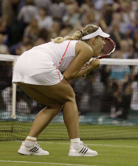 Angelique Kerber of Germany reacts as she defeats Sabine Lisicki of Germany in a quarterfinals match at the All England Lawn Tennis Championships at Wimbledon.