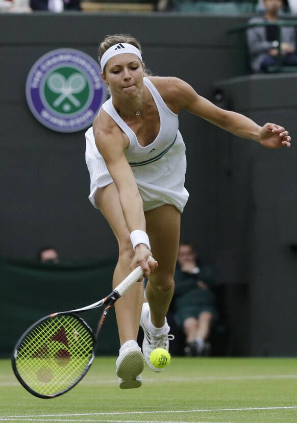 Maria Kirilenko of Russia plays a return to Agnieszka Radwanska of Poland during a quarterfinals match at the All England Lawn Tennis Championships at Wimbledon.