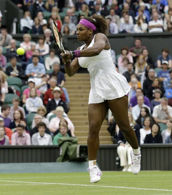 Serena Williams of the United States plays a return to Petra Kvitova of the Czech Republic during a quarterfinals match at the All England Lawn Tennis Championships at Wimbledon.