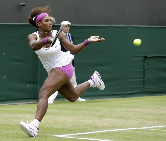 Serena Williams of the United States plays a return to Yaroslava Shvedova of Kazakhstanduring a fourth round singles match at the All England Lawn Tennis Championships at Wimbledon.