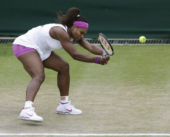 Serena Williams of the United States returns a shot to Yaroslava Shvedova of Kazakhstan during a fourth round women's singles match at the All England Lawn Tennis Championships at Wimbledon.