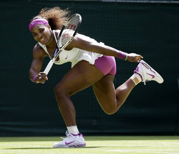 Serena Williams of the United States plays a return to Zheng Jie of China during a third round women's singles match at the All England Lawn Tennis Championships at Wimbledon.