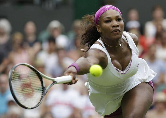 Serena Williams of the United States plays a return to Melinda Czink of Hungary during a second round women's singles match at the All England Lawn Tennis Championships at Wimbledon.