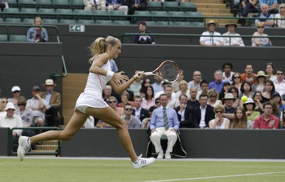 Arantxa Rus of Netherlands returns a shot against Samantha Stosur of Australia during a second round women's singles match at the All England Lawn Tennis Championships at Wimbledon.