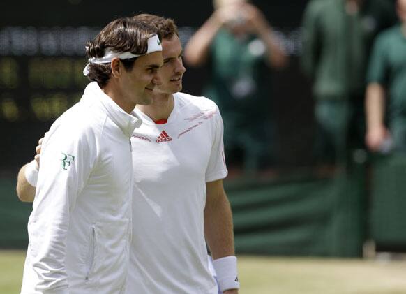 Andy Murray of Britain, right, and Roger Federer of Switzerland pose for a photograph ahead of the men's singles final match at the All England Lawn Tennis Championships at Wimbledon, England, Sunday, July 8, 2012. 