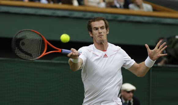 Andy Murray of Britain plays a shot to Roger Federer of Switzerland during the men's final match at the All England Lawn Tennis Championships at Wimbledon, England, Sunday, July 8, 2012.