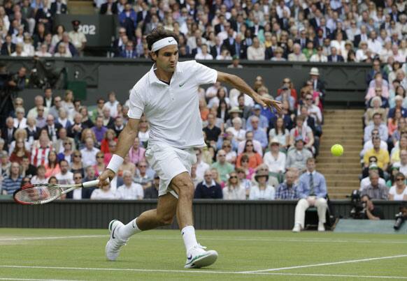 Roger Federer of Switzerland plays a shot to Andy Murray of Britain during the men's final match at the All England Lawn Tennis Championships at Wimbledon, England, Sunday, July 8, 2012.