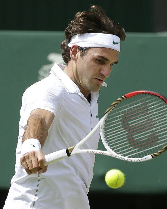 Roger Federer of Switzerland plays a shot to Andy Murray of Britain during the men's singles final match at the All England Lawn Tennis Championships at Wimbledon, England, Sunday, July 8, 2012. 