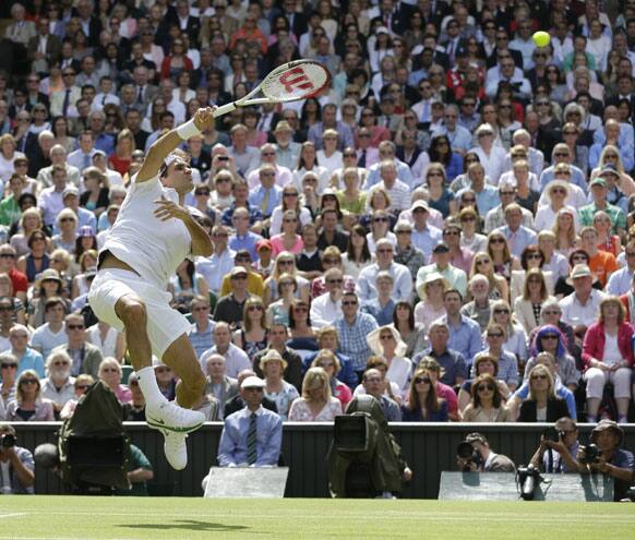 Roger Federer of Switzerland returns a shot to Andy Murray of Britain during the men's final match at the All England Lawn Tennis Championships at Wimbledon, England, Sunday, July 8, 2012.