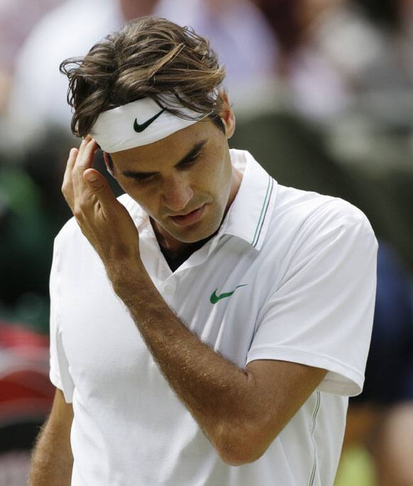 Roger Federer of Switzerland reacts during the men's singles final match Andy Murray of Britain at the All England Lawn Tennis Championships at Wimbledon, England, Sunday, July 8, 2012. 