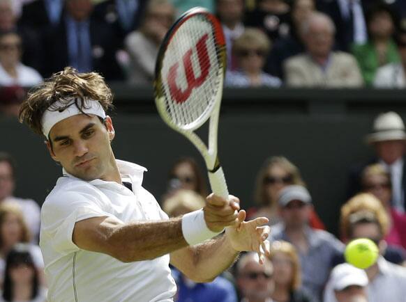 Roger Federer of Switzerland plays a shot to Andy Murray of Britain during the men's final match at the All England Lawn Tennis Championships at Wimbledon.