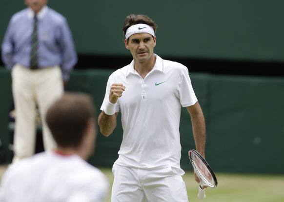 Roger Federer of Switzerland reacts after winning the second set against Andy Murray of Britain during the men's singles final match at the All England Lawn Tennis Championships at Wimbledon, England, Sunday, July 8, 2012