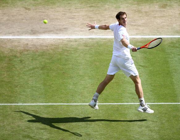 Andy Murray of Britain plays a shot to Roger Federer of Switzerland during the men's singles final match at the All England Lawn Tennis Championships at Wimbledon, England, Sunday, July 8, 2012.