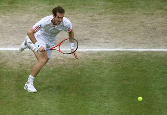 Andy Murray of Britain runs for a shot during the men's singles final match against Roger Federer of Switzerland at the All England Lawn Tennis Championships at Wimbledon, England, Sunday, July 8, 2012