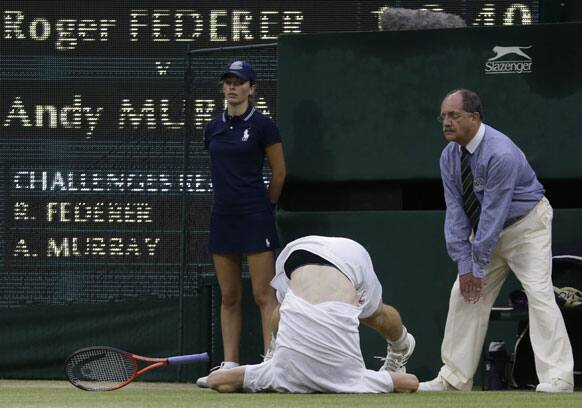 Andy Murray of Britain takes a tumble during the men's singles final match against Roger Federer of Switzerland at the All England Lawn Tennis Championships at Wimbledon, England, Sunday, July 8, 2012