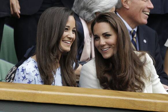 Kate, Duchess of Cambridge, right, speaks with her sister Pippa Middleton as they arrive to watch Roger Federer of Switzerland face Andy Murray of Britain during the men's final match at the All England Lawn Tennis Championships at Wimbledon.