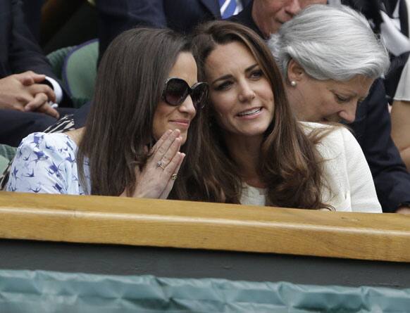 Kate, Duchess of Cambridge, front right, speaks with her sister Pippa Middleton as they arrive to watch Roger Federer of Switzerland face Andy Murray of Britain during the men's final match at the All England Lawn Tennis Championships at Wimbledon.