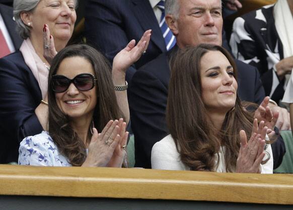 Kate, Duchess of Cambridge, right, and her sister Pippa Middleton, left, applaud before the start of the men's singles final between Roger Federer of Switzerland and Andy Murray of Britain at the All England Lawn Tennis Championships at Wimbledon.