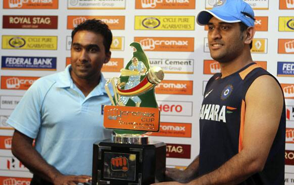 Indian cricket captain Mahendra Singh Dhoni, right, and Sri Lanka's counterpart Mahela Jayawardene pose with the winner's trophy of their 5-match ODI series