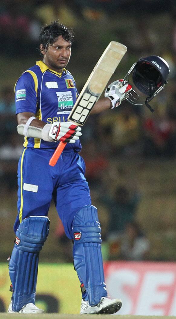 Sri Lanka's batsman Kumar Sangakkara celebrates after scoring a century during the first one-day international cricket match between Sri Lanka and India in Hambantota.