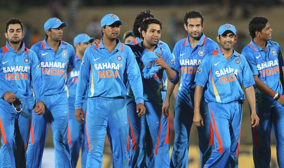 Victorious Indian teammates walk back to the pavilion after beating Sri Lanka by 21-runs during the first one-day international cricket match between Sri Lanka and India in Hambantota.