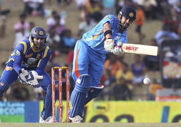 Gautam Gambhir, right, bats as Sri Lanka's wicket keeper Kumar Sangakkara, left, watches during the second one-day international cricket match between Sri Lanka and India in Hambantota.