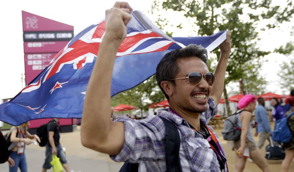 Zaki Abdullah carries a New Zealand flag as he walks into the Olympic Park before the Opening Ceremony for the 2012 Summer Olympics in London.