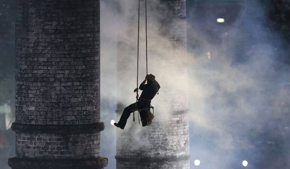 An artist is lowered down during the Opening Ceremony at the 2012 Summer Olympics in London.