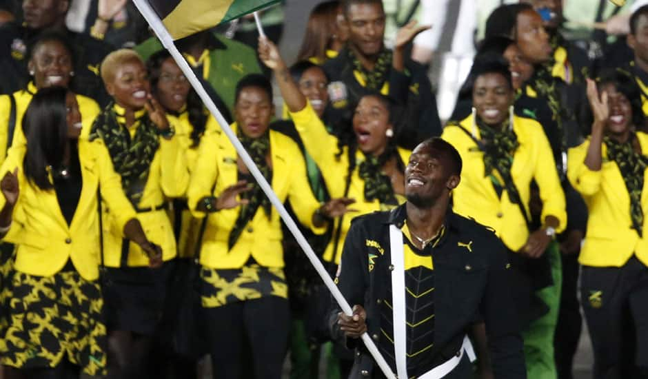 Jamaica's Usain Bolt carries the flag during the Opening Ceremony at the 2012 Summer Olympics in London.