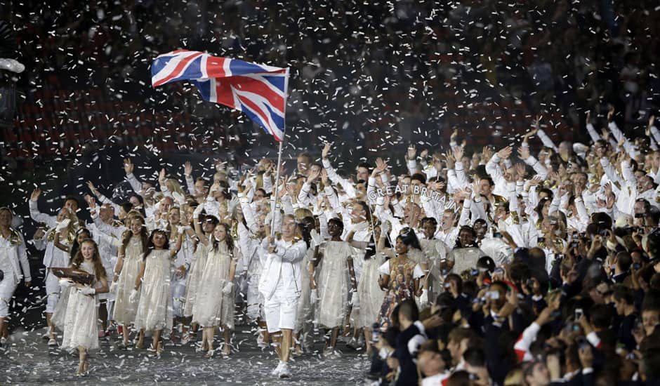 Great Britain's Chris Hoy carries the national flag as confetti surrounds the team during the Opening Ceremony at the 2012 Summer Olympics in London.