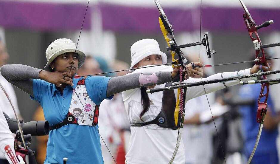 Deepika Kumari shoots next to Mexico's Aida Roman during an individual ranking round at the 2012 Summer Olympics in London.