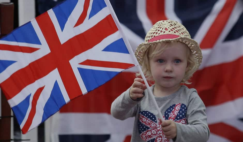 A young girl shows her support for the Great Britain team at a park screening a live telecast of the opening ceremony of the 2012 Summer Olympics in London.