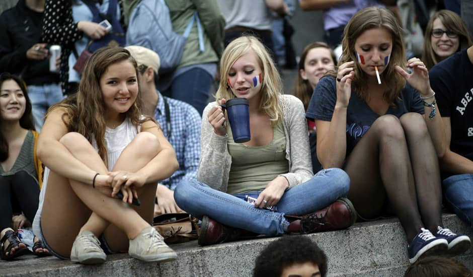 People gather at Trafalgar Square in downtown London to watch the clock countdown prior to the Opening Ceremony of the 2012 Summer Olympics in London. 