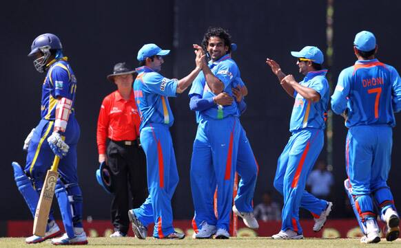 Zaheer Khan celebrates the dismissal of Sri Lanka's batsman Tillakaratne Dilshan with teammates Gautam Gambhir, second left and Suresh Raina during the third one-day international cricket match between India and Sri Lanka in Colombo.