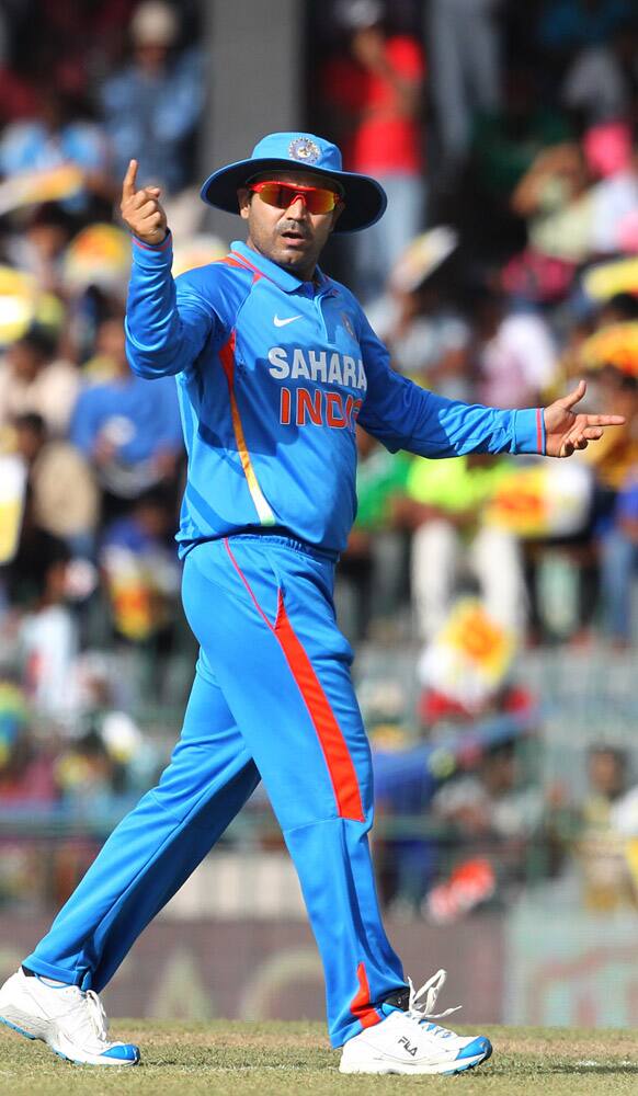 Virender Sehwag gestures as he sets the field during the third one-day international cricket match between India and Sri Lanka in Colombo.