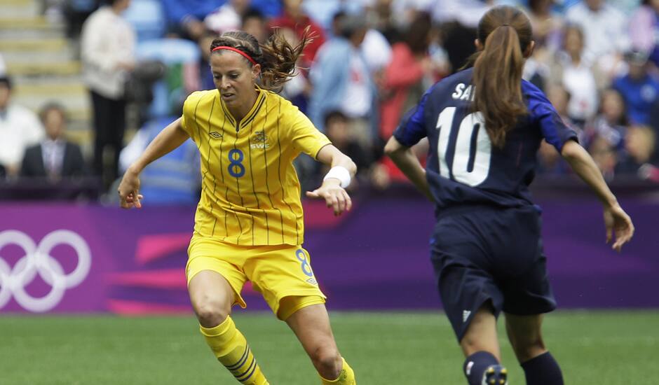 Sweden's Lotta Schelin, left, battles for the ball against Japan's Homare Sawa, right, during the group F women's soccer match between Japan and Sweden at the London 2012 Summer Olympics.