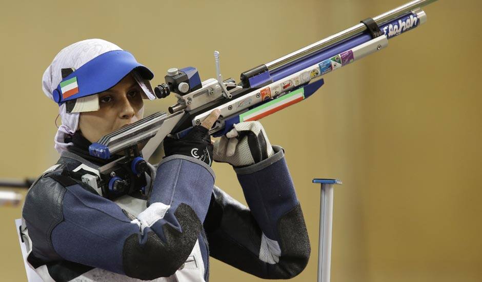 Iran's Elaheh Ahmadi shoots during the women's 10-meter air rifle final at the 2012 Summer Olympics.