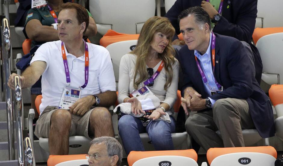 US Republican presidential candidate Mitt Romney, right watches the opening day of swimming competitions at the Aquatics Centre in the Olympic Park during the 2012 Summer Olympics in London.